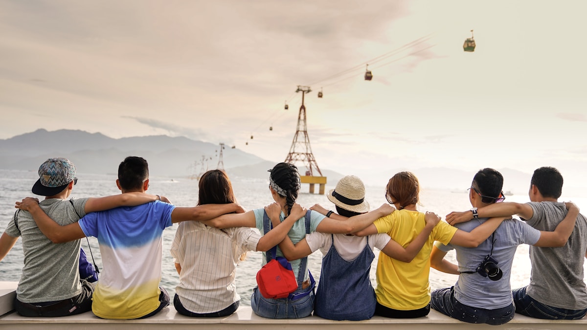 A group of friends laughing together outdoors - finding community and belonging